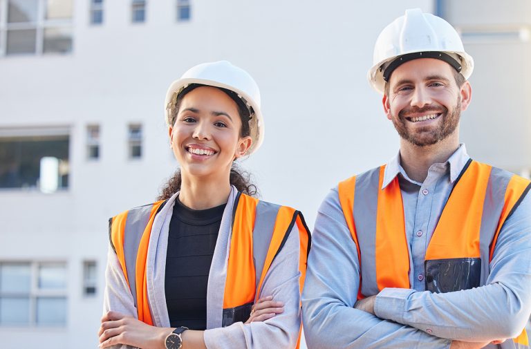 Proud team of engineers at a construction site, representing development, project management, and business growth in action